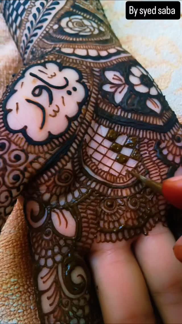 Bridal mehndi being applied in fine detail at our salon
